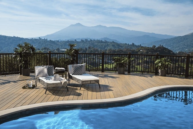 Pool Deck Featuring TimberTech PRO Legacy in Tigerwood Radiance Rail Composite with outdoor furniture