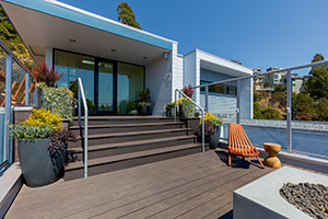Gray-Composite-Decking-TimberTech-AZEK-Vintage-Collection-Dark-Hickory-Deck-With-Mid-Centry-Modern-Home Gray composite decking fits any style