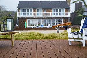 Deck featuring TimberTech AZEK Vintage Collection Mohagany with white adirondack chair