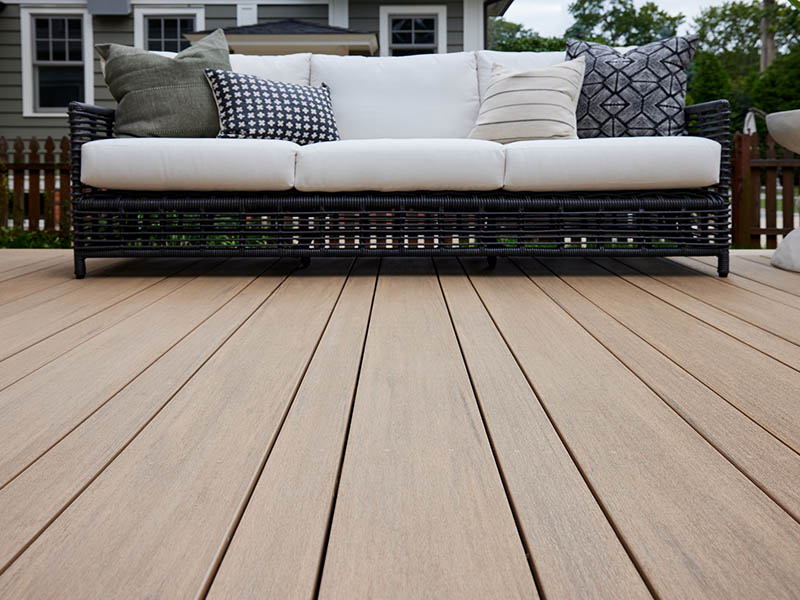 Deck ideas with couch and pillows on outdoor composite deck