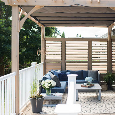 Deck furniture and plants under pergola
