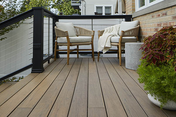 A deck renovation project featuring composite decking with realistic wood looks