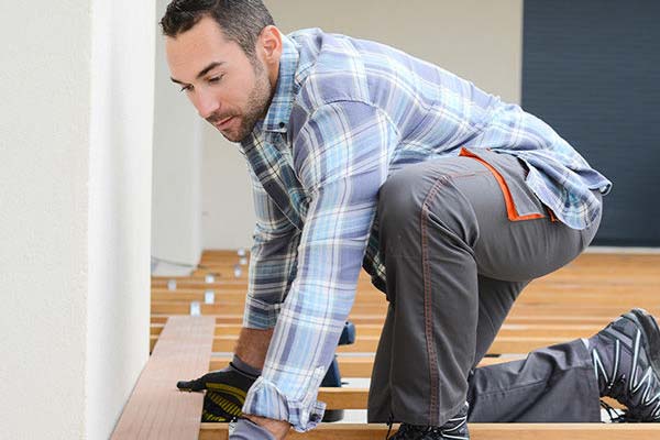 Contractor putting down deck flooring