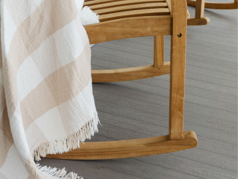 Close up shot of the leg of a rocking chair on the porch built with Coastline boards