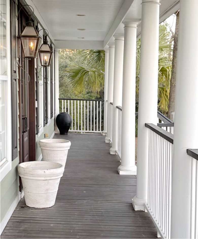 Amy's front porch boards before the update, the boards were dirty, uneven, and showed signs of serious wear.