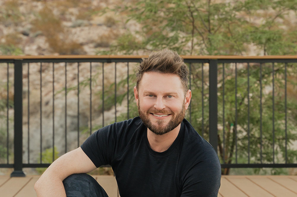 Bobby Berk sits on his TimberTech deck