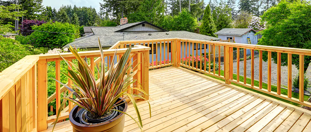An example of a pressure-treated wood deck with a planter box and deck railing.