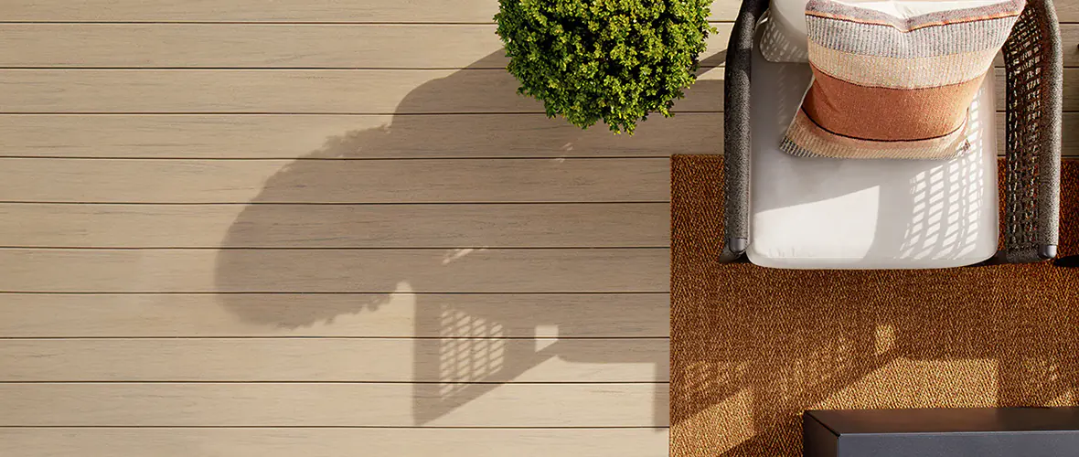 An example of a composite deck in a light tan color with complementary outdoor furniture.