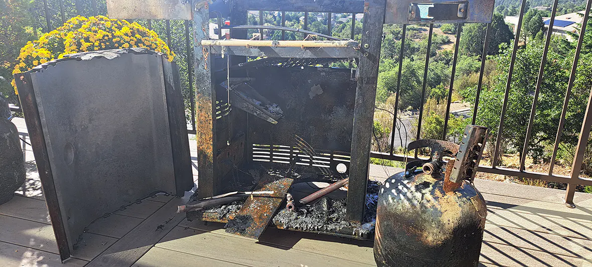 The remains of a grill that caught on fire on a TimberTech deck