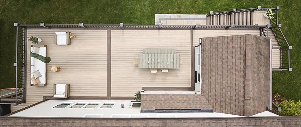 Drone shot of a light tan second story deck that has dark brown deck boards picture framing the edges of the deck