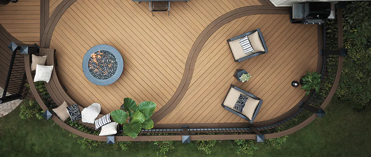 Aerial shot of a two-toned deck built with light and dark brown deck boards with curved boards creating a picture-framed design