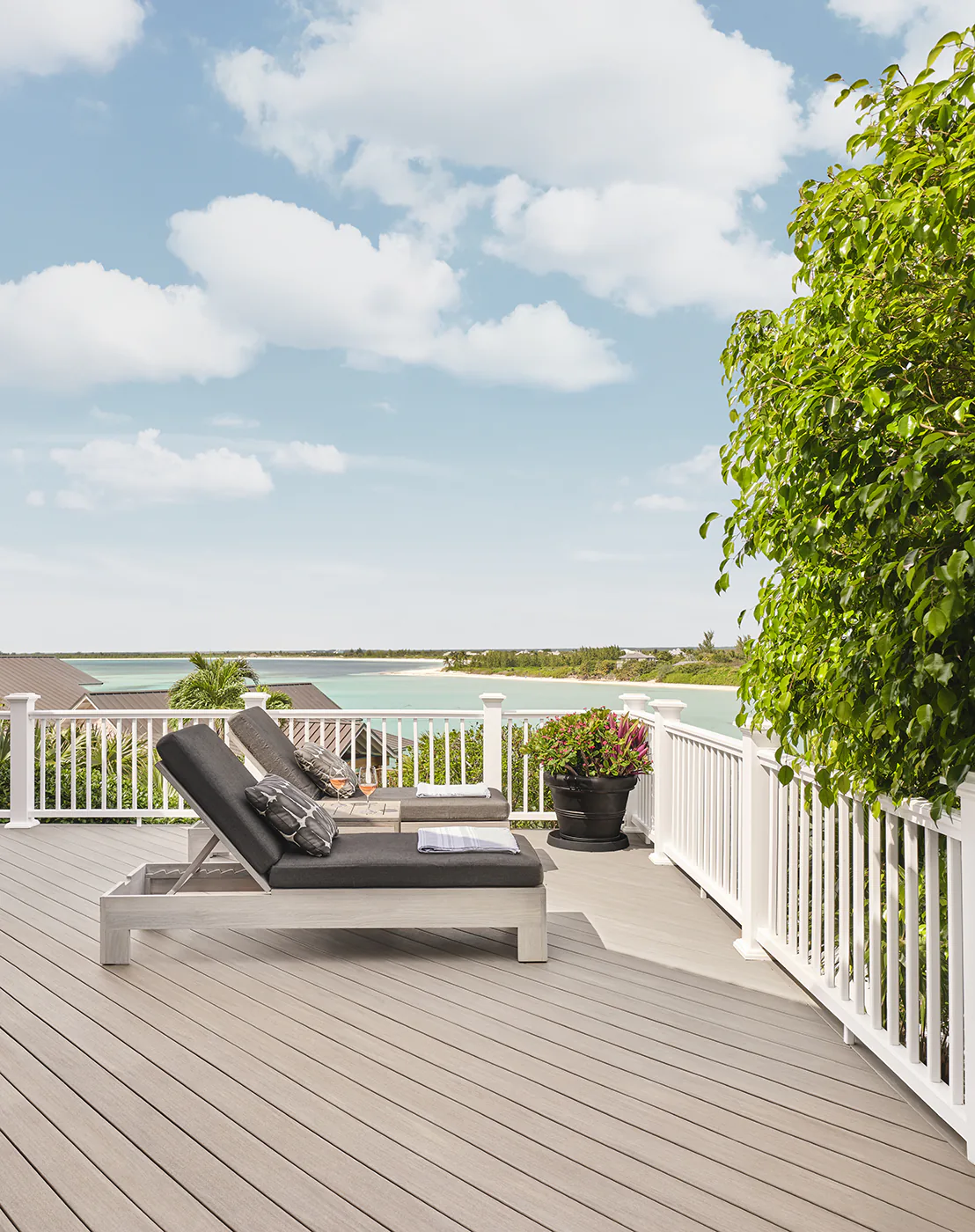 Side view of two lounge chairs on the deck with a beautiful view of the Bahamas in the background.