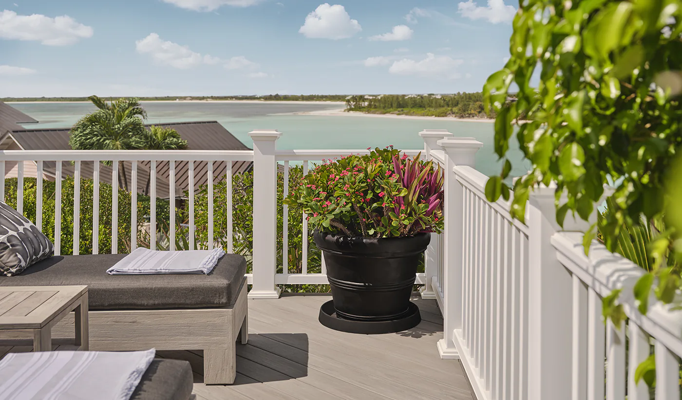 Zoomed in view of the chairs with the deck and white railing closer in focus.