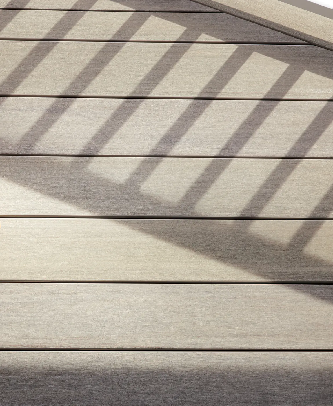 Up close view of Darren's deck which features tan hues in the sunlight despite its gray color.