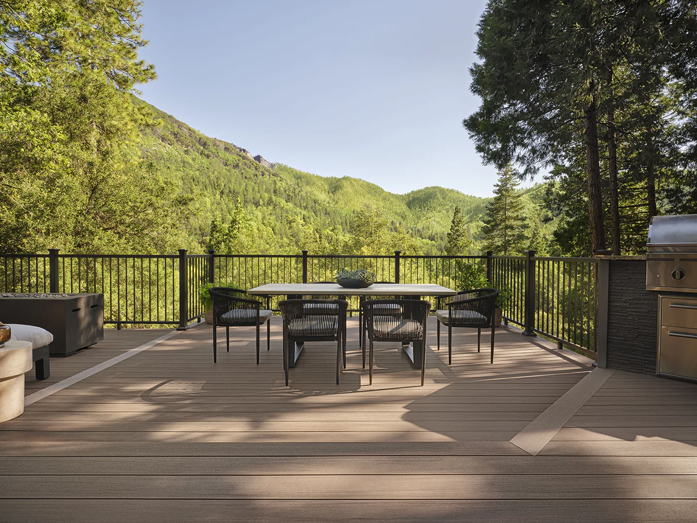 An outdoor dining room table and chairs on Tiffani's deck