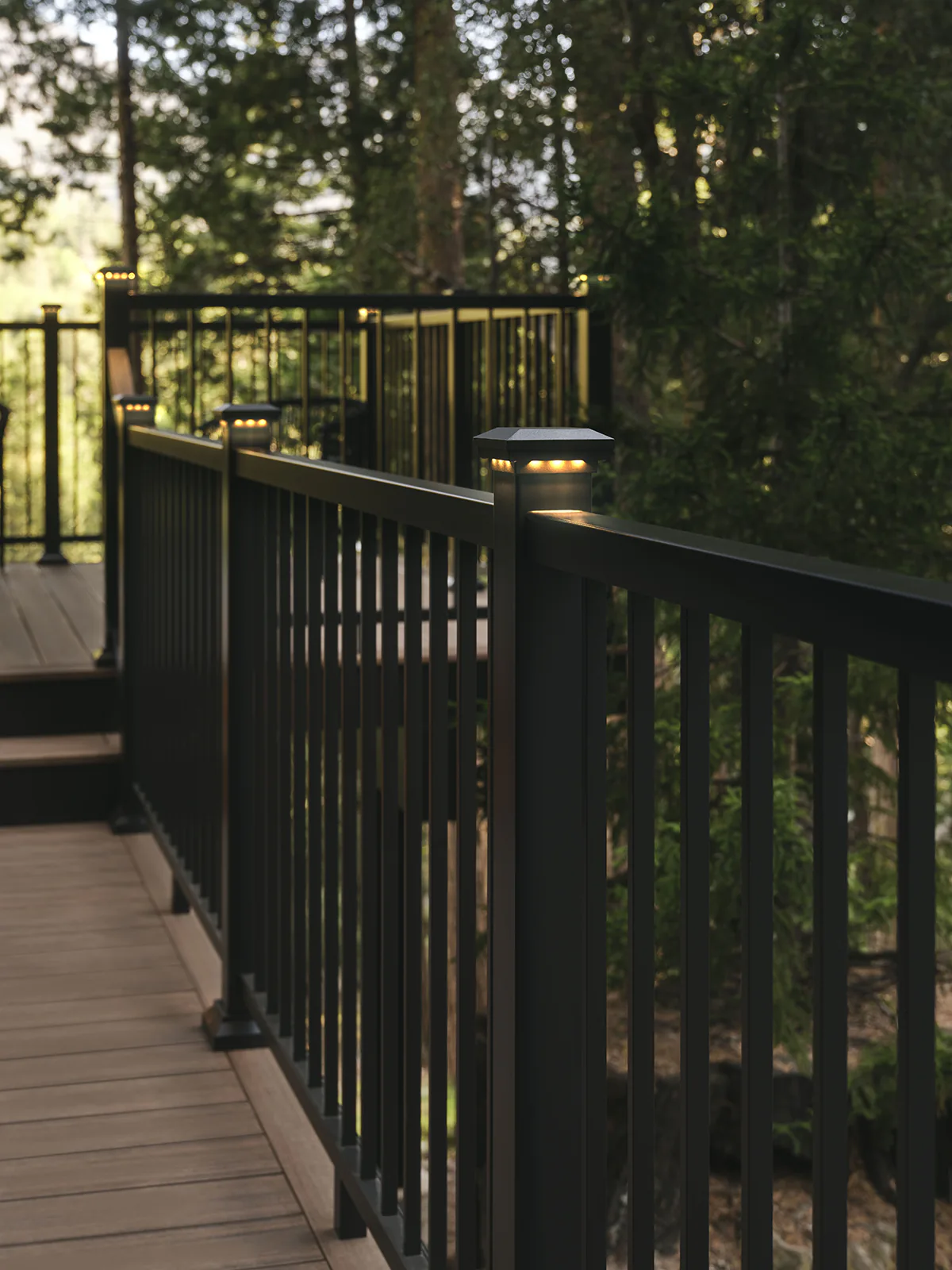 Impression rail express railing puts the finishing touch on Tiffani's deck, post cap lights glow on the top of each post