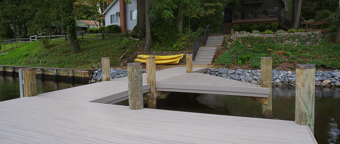 Light gray dock on the water with cut out spaces for boat parking