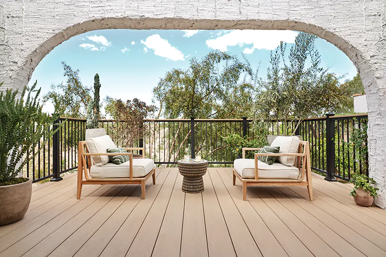 Extra wide light tan deck boards match the surrounding environment on a deck in the desert
