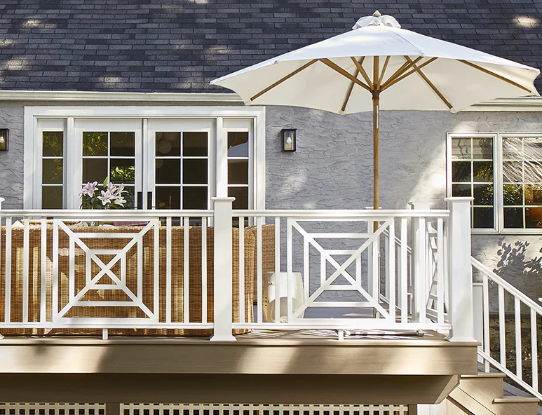 View of Mary Kate's deck from the backyard, her deck sits a few feet above ground level and has several stairs leading up to it