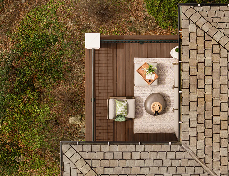 Aerial view of the uncovered corner of Marianne's deck that extends past the roof of the home.