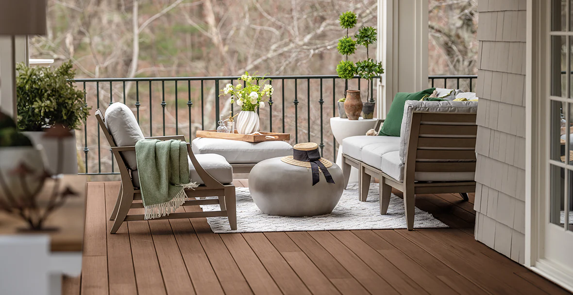 An outdoor living room with lounge chairs and a modern rock-shaped table in the middle create intimate spaces throughout an otherwise large outdoor space.